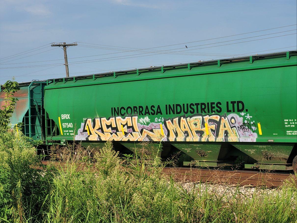 On a green rail car labeled Incobrasa Industries, KEEL MARFA in yellow letters on purple background.