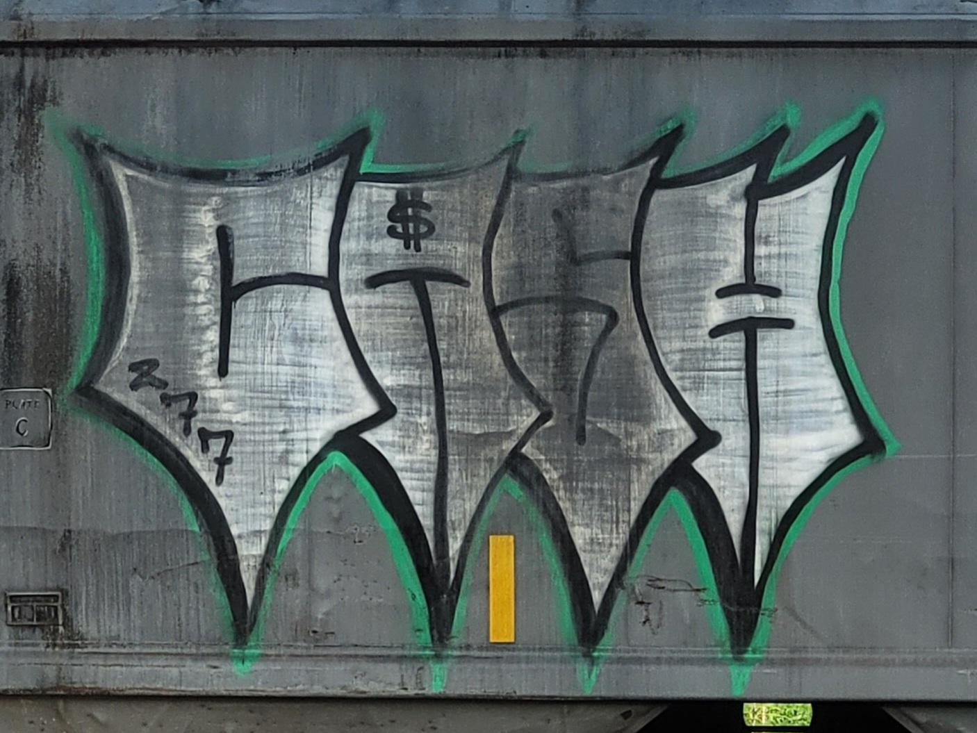 CASH. Four five-pointed letters that look kind of like throwing stars. Elongated and turned so that each has a long point reaching down. Scribbly gray gradient that looks like polished metal, edged in black and then electric green. A 277 on the C and a $ on the A.